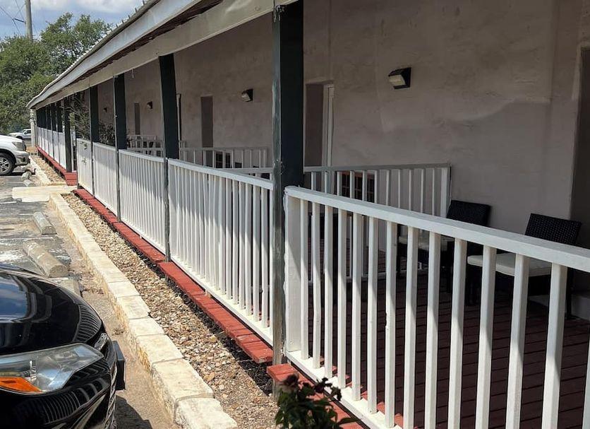 Covered walkway with white railing along the guest rooms