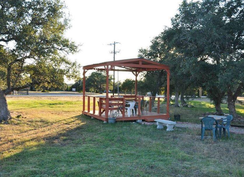 Red pergola with picnic tables on the lawn