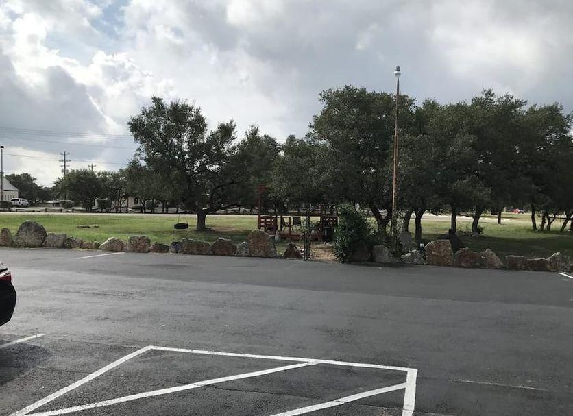 Outdoor seating under the trees at Outpost Motel
