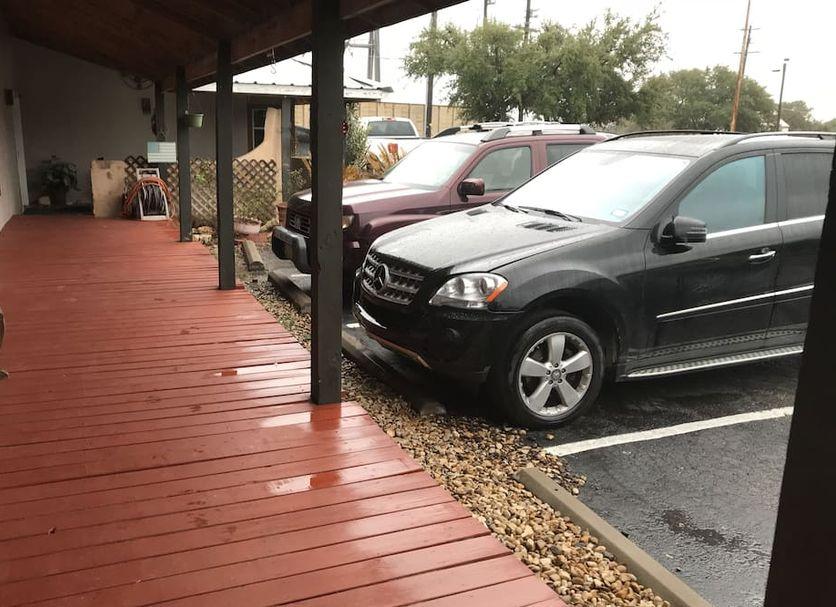Planted beds and open lawn beside the motel