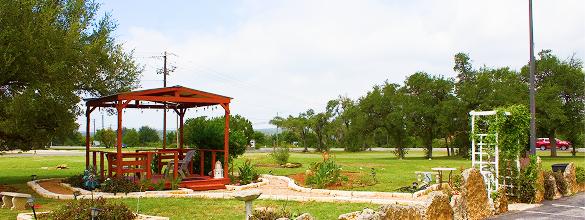 Pergola and planted beds on the lawn at Outpost Motel