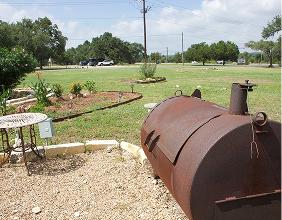 Barbecue smoker beside the lawn and picnic area