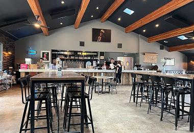 Tasting room with high-top tables and a bar